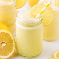 lemonade in a jar with lemon slices and a straw